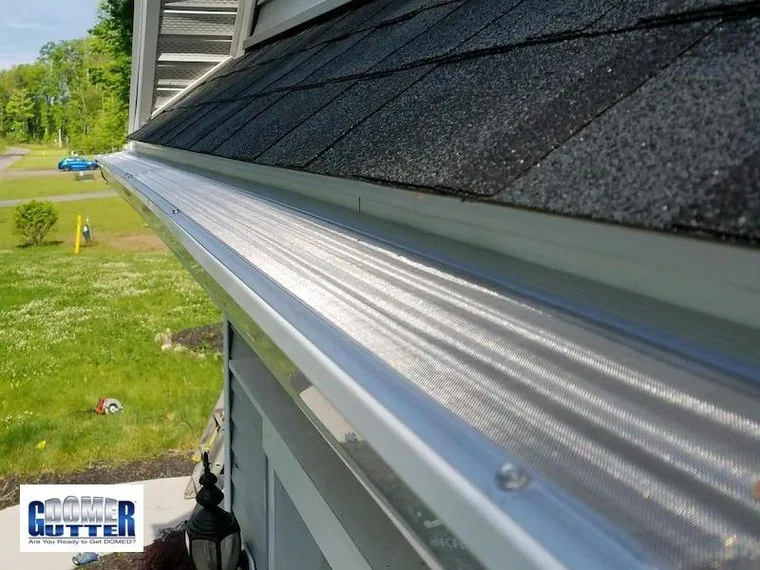 GutterDome gutter guard fitted to a gutter run meeting a downspout.