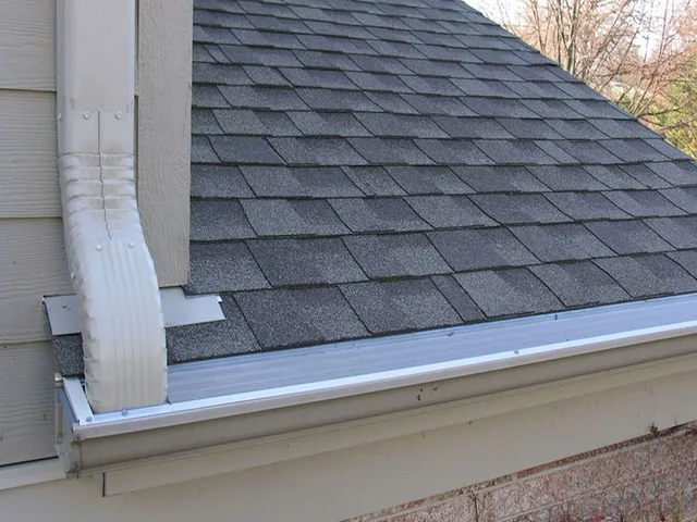 A custom GutterDome insert fitted to a first-story gutter run on a comp shingle roof.