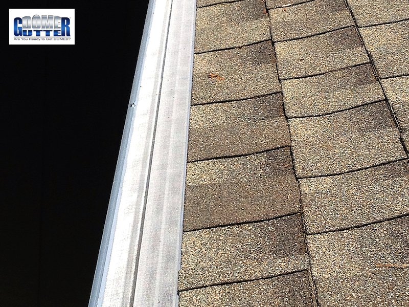 GutterDome extruded aluminum gutter guard installed on brown residential home