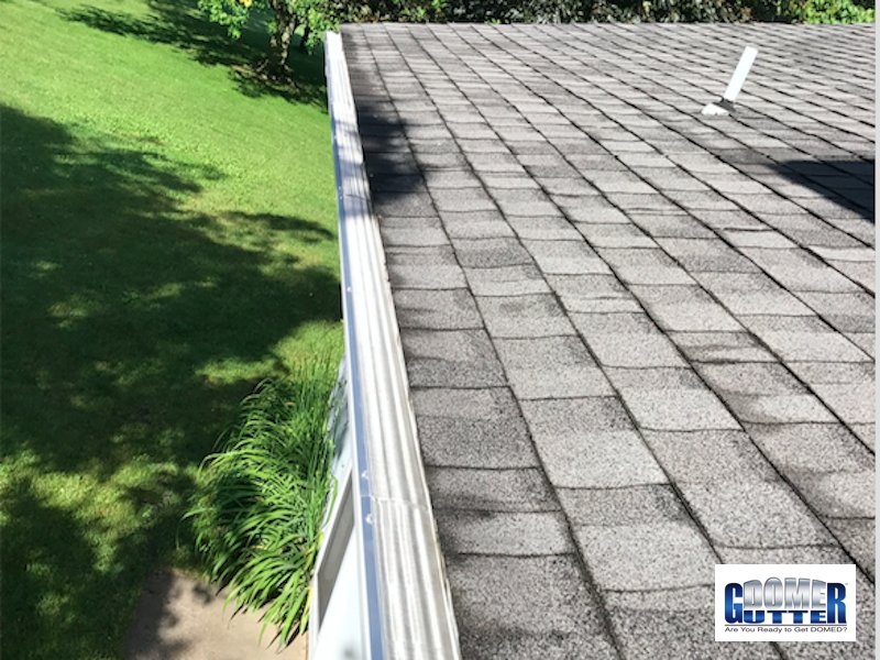 GutterDome gutter protection system on home with lawn — professional dealer installation